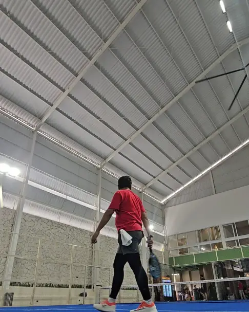 A player on the blue court under the high roof